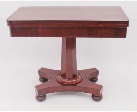 A mid-19th century mahogany D-shaped foldover card table - the top lined with green baize, raised on an octagonal tapered col