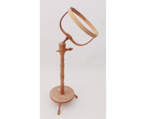 A light oak needlework stand - the circular bentwood, adjustable frame on a turned column with a turned dish base with tripod