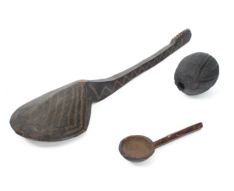 A carved coconut 'bugbear', probably 19th century - carved with geometric decoration, 12.5cm long; together with a&nbsp;large