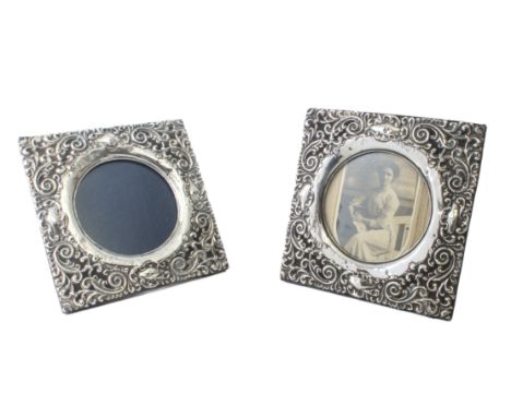 A pair of George V silver easel picture frames - Chester 1933. square with repouss&eacute; foliate scroll and cabochon decora