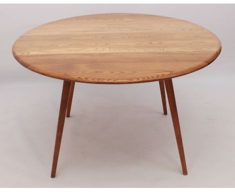 A Ercol mid-elm dropflap dining table - the oval dropflap top woth slide-out supports for the flaps, raised on splayed, squar
