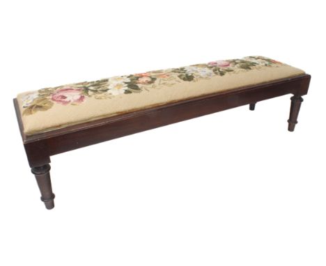 A 19th century style mahogany fender stool - mid-20th century, the drop-in seat with floral embroidery, raised on turned tape