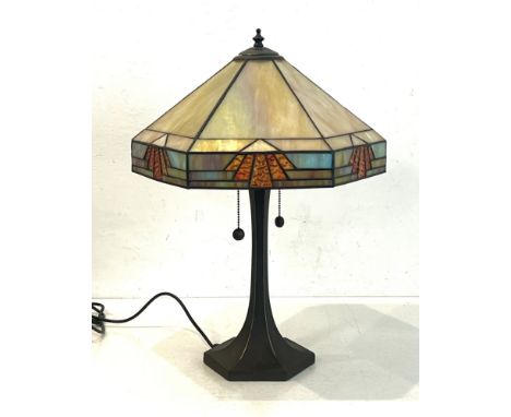 A Tiffany style table lamp - the hexagonal opaque marbled and stained glass shade in an Art Deco style, on a tapering bronzed