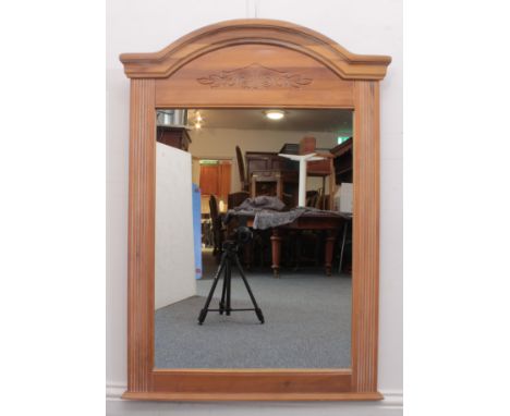 A modern American arched wooden console mirror - the moulded arched top on reeded pilasters, above a foliate scroll carved fr
