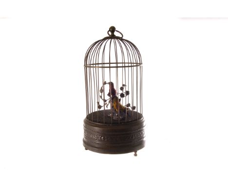 A late Victorian clockwork bird cage automaton, the brass case having a yellow and a red feathered bird, appears to operate w