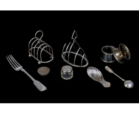 A small mix of silver, including a sauce ladel, a caddy spoon, a toast rack, napkin rings, and more (parcel) 