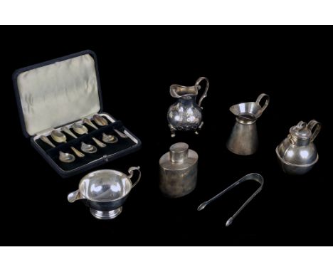 A collection of silver, including a George V tea caddy and two milk jug, a Jersey milk jug, two cased sets of teaspoons, a pa
