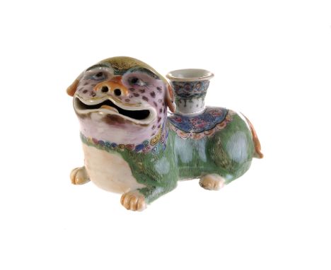 A fine late 18th / early 19th century Chinese porcelain figural candleholder, modelled as a Buddhist lion painted in enamels 