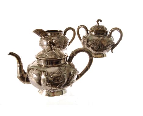 A Chinese white metal three piece tea set, marked ZEEWO with a character mark, the teapot, milk jug and sugar basin with bamb