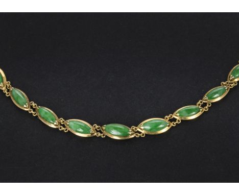 A Chinese yellow metal and jade bracelet, the line style bracelet having possibly 14ct gold mounts set with graduating polish