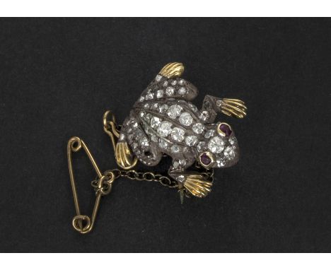 An Edwardian diamond and ruby set frog brooch, the old cuts in silver setting on a gold mount 