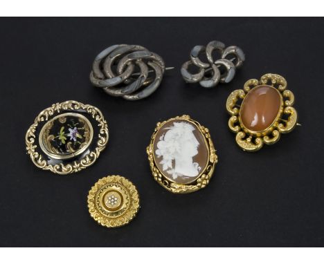 A group of six antique and later brooches, including two silver examples with inlaid agate, a cameo and pinchbeck brooch, a m