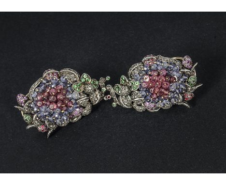 A pair of diamond, sapphire, ruby and gem set earstuds, of floral design, the pave set diamonds surrounding a sapphire and be