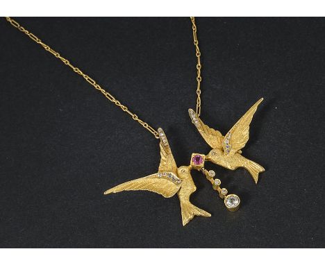 A pretty continental yellow metal and gem set bird pendant necklace, having two exotic birds in flight with rose cuts to thei