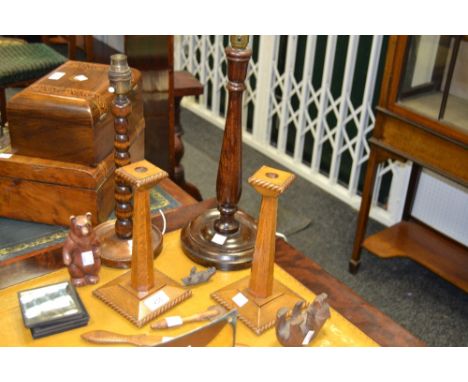 A pair of oak candlesticks; a turned bobbin mahogany table lamp; another; lantern slides; a Bavarian carved bear; pastry mark