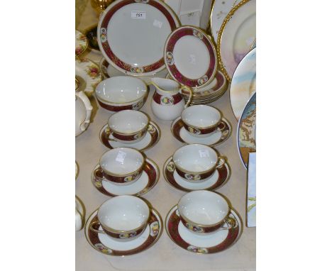 A Japanese eggshell porcelain six setting tea service, decorated with flowers, inc two bread plates, six trios etc 