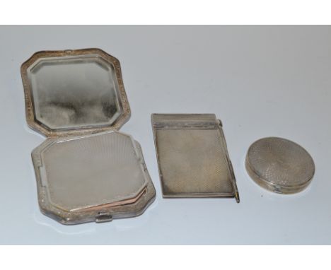 A silver circular compact; a canted square compact; a silver aide memoire   (3)