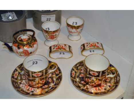 A Royal Crown Derby miniature 2649 pattern Teapot;  pair of egg cups;  two 2451 pattern coffee cans and saucers, a pair of na