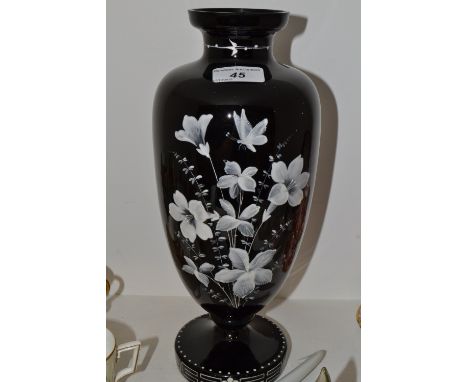 A Victorian ruby glass pedestal ovoid vase, painted in white with stylised flowers, 33cm high, c.1870