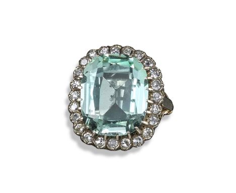 An aquamarine and diamond cluster ring, the cushion-shaped aquamarine weighs approximately 11.00cts and is set within a surro