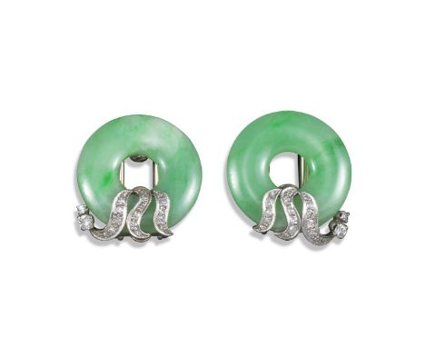 A pair of jade and diamond clips, the circular jade discs decorated with diamond scrolls in white gold, 2.7cm wide Accompanie
