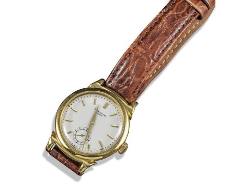 PATEK PHILIPPE - An 18ct gold Calatrava wrist watch, signed white dial with baton numerals and subsidiary seconds dial, manua
