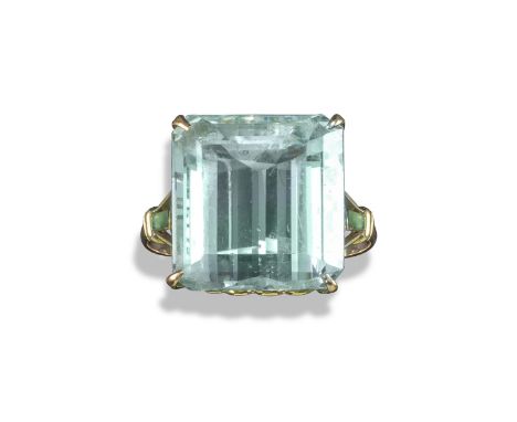An aquamarine-mounted gold ring, the square-shaped aquamarine is set in gold with stylised fleur-de-lys shoulders, size Q 1/2