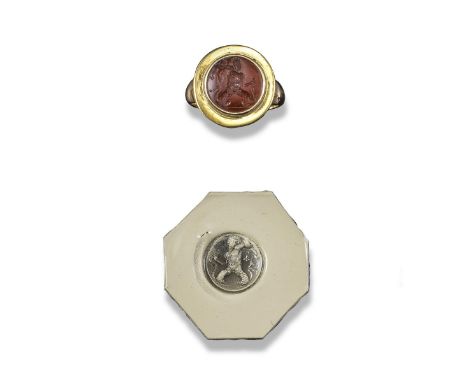 A circular carved carnelian intaglio, possibly Classical, depicting a merman with bifurcated tail, later mounted as a gold ri
