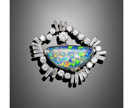 A black opal and diamond brooch, the solid black opal cabochon is set within a graduated border of alternately-set baguette-s