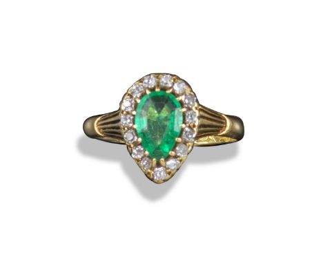 A late 19th century emerald and diamond cluster ring, the pear-shaped emerald is set within a surround of old cushion-shaped 