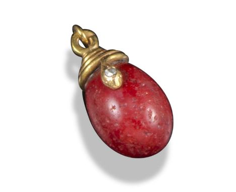 A miniature purpurine egg pendant by Fabergé, surmounted with a coiled snake and with a small rose-cut diamond set to its hea