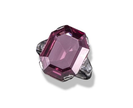 A pink spinel ring, the emerald-cut pink spinel weighs 10.10cts (known weight) and flanked with tapered baguette white stone 