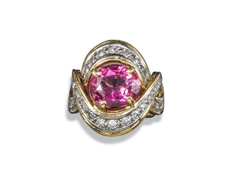 A 18ct white gold, pink tourmaline and diamond cluster ring, 1950s, the oval-shaped rubelite is claw-set within a surround of
