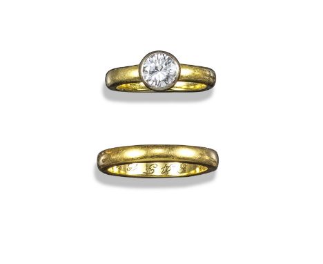 A diamond solitaire ring and wedding band, the round brilliant-cut diamond weighs approximately 0.60cts and is rubover-set in