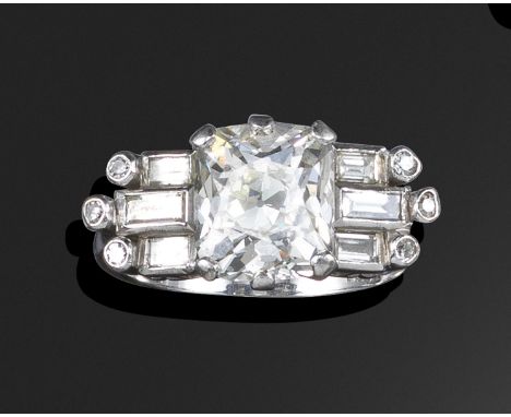A diamond ring, the cushion-shaped diamond weighs 3.68cts (known weight) and is set between three baguette-shaped and three s