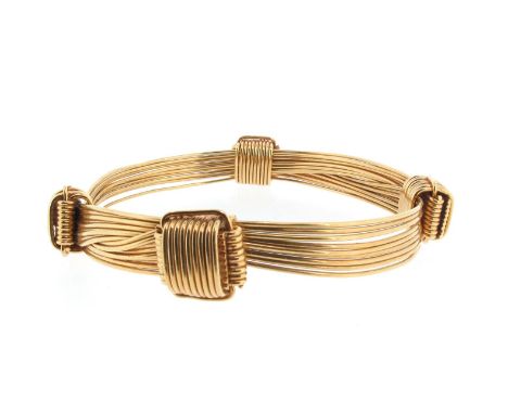 A yellow gold 'Elephant Hair' bangle by Gucci, the adjustable bracelet formed with multiple polished gold wires to resemble i