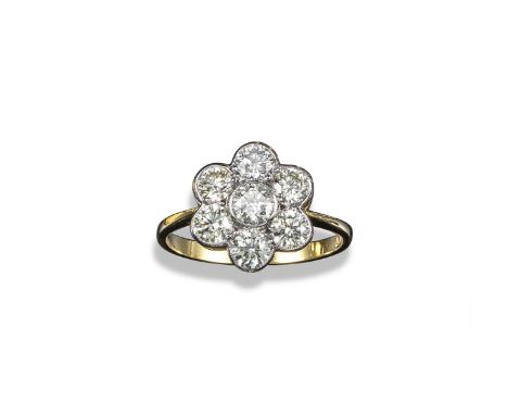 A diamond cluster ring, the seven round brilliant-cut diamonds weigh approximately 1.65cts total and are set in yellow and wh