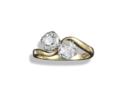 A diamond two-stone crossover ring, the old circular-cut diamonds weigh 1.00 and 0.90cts are set in an 18ct yellow gold and p