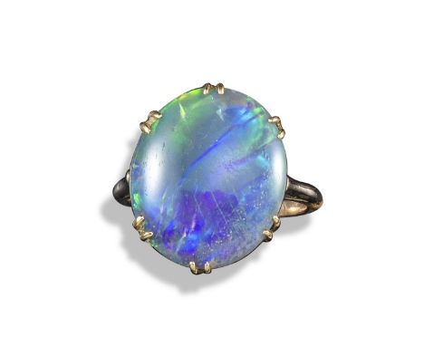 An opal and yellow gold ring, the solid opal is claw-set in yellow gold, size M 1/2