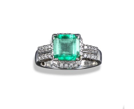 An emerald and diamond ring, the square-shaped emerald set within a surround of small circular-cut diamonds, with further cir