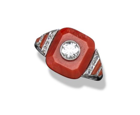 An Art Deco coral and diamond ring, the central cushion-shaped coral panel surmounted with a circular-cut diamond with altern