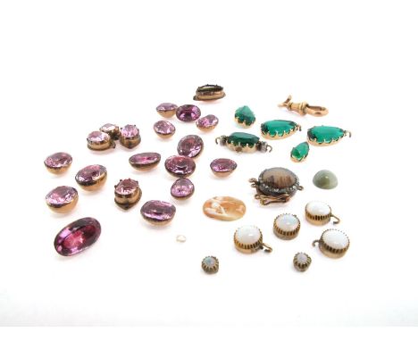 An assorted collection of cut-down stone-set collets, including a moss agate on guilloche ground-mounted gold clasp, within a
