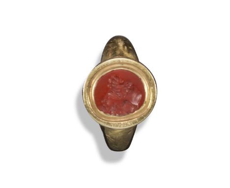 A small oval carved red jasper intaglio-mounted gold ring, possibly Romano-British, 2nd - 3rd century AD and from a Roman leg