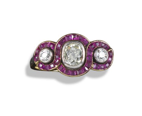 A diamond and ruby three-stone ring, set with an oval-shaped and two shoulder circular-cut diamonds in yellow gold, with conj
