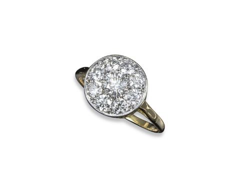 A diamond cluster ring, the centre round brilliant-cut diamond weighs approximately 0.30ts and is pave-set within a surround 