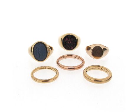 An 18ct gold signet ring, mounted with a bloodstone engraved with arms, an 18ct gold ring mounted with a blue paste intaglio,