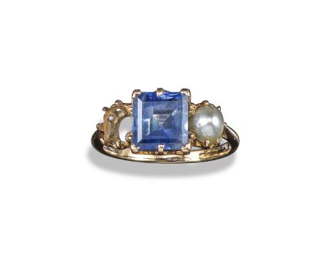 A sapphire and pearl three stone ring, the square-shaped sapphire is flanked with pearls (one missing) claw-set in yellow gol