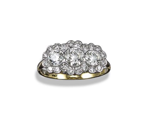 A diamond cluster ring, the three centre graduated round brilliant-cut diamonds are millegrain-set within a surround of small