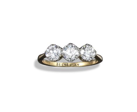 A diamond three-stone ring, the three old circular-cut diamonds are set in yellow gold and platinum, size N 1/2