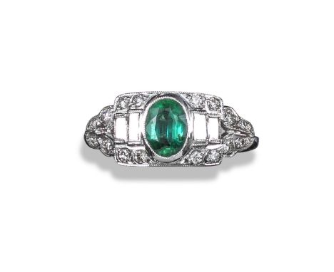 An emerald and diamond cluster ring, the centre oval-shaped emerald weighs approximately 0.50cts and is rub-over set within a